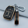 A black TPU smart key fob cover with gold accents attached to a silver keychain.