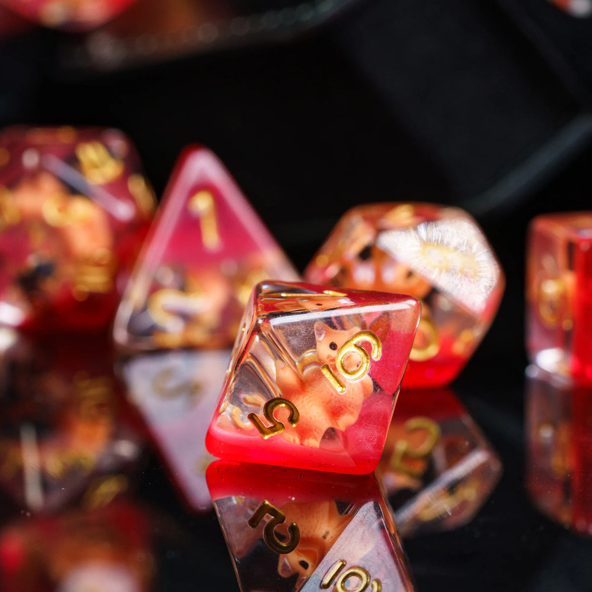 A close-up of a set of translucent red and amber resin dice used for tabletop role-playing games