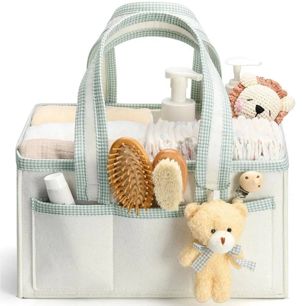 A floral diaper organizer bag with multiple compartments filled with baby toiletries and a teddy bear.