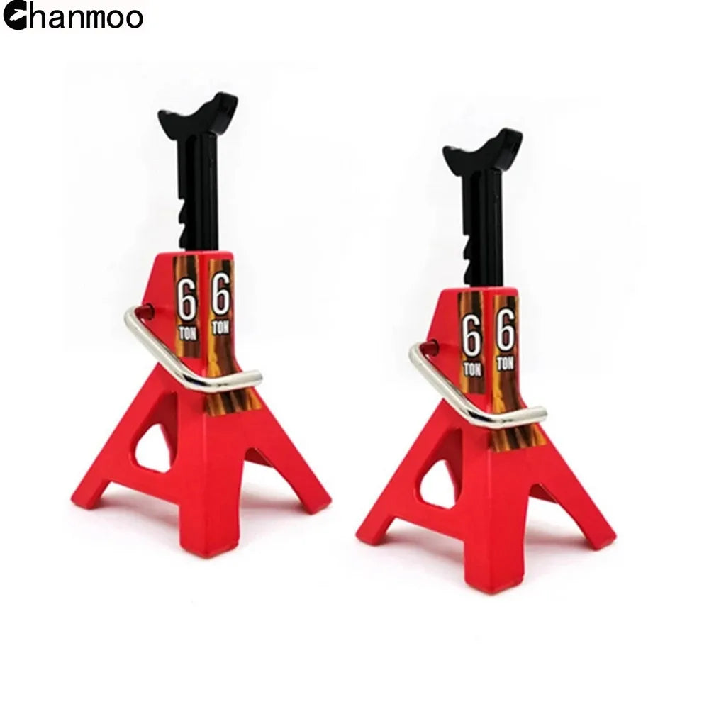 A pair of red metal jack stands with black lifting posts used for heavy-duty metal lifts on RC cars.
