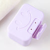 A purple smiley face lidded soap dish for bathroom and travel, shown in a close-up view.