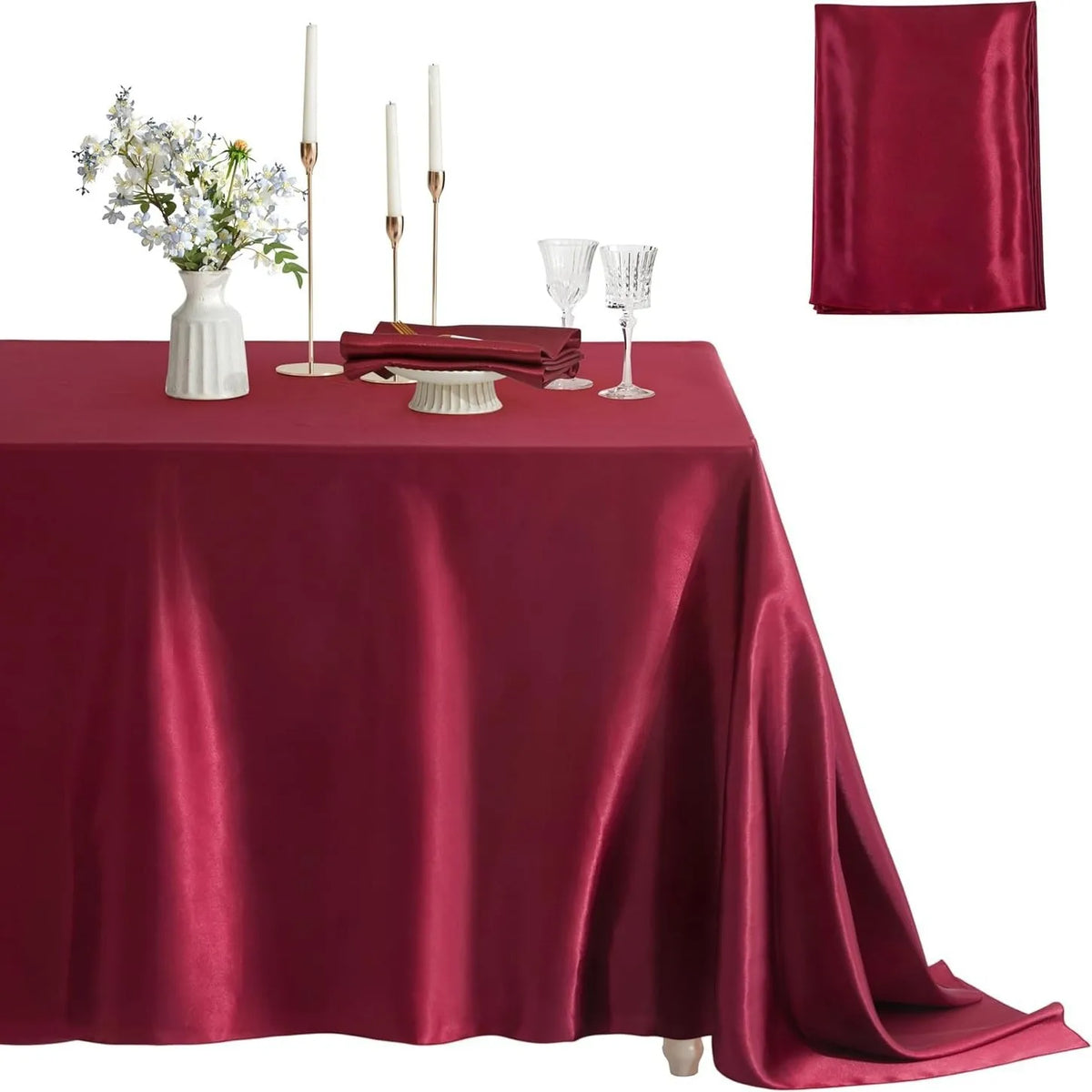 A deep burgundy satin tablecloth set for dining or events, featuring a square cover and elegant glassware.