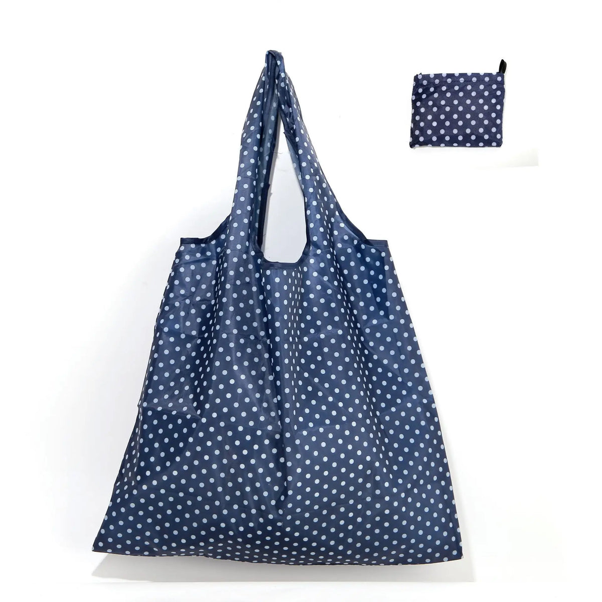 A navy blue reusable shopping tote bag with white polka dots and a matching small carry pouch.