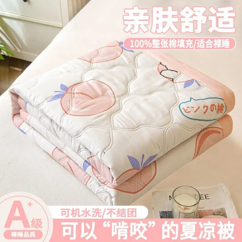 A stack of white and pink quilted blankets or quilts for summer comfort