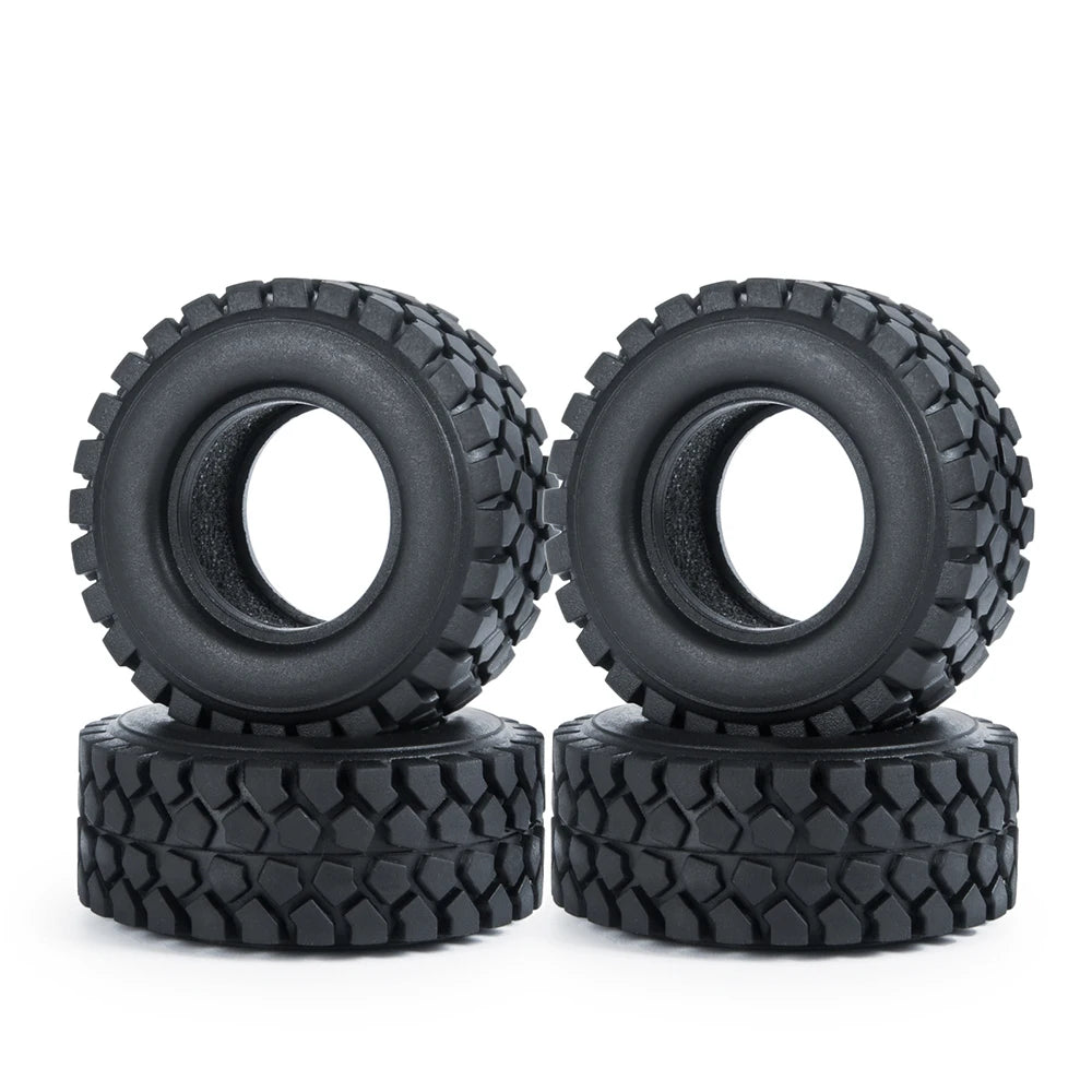 A pair of black rubber mud terrain tires for Axial SCX24 and TRX4M