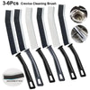A set of six black and white crevice cleaning brushes for tight spaces, including a cleaning brush head.