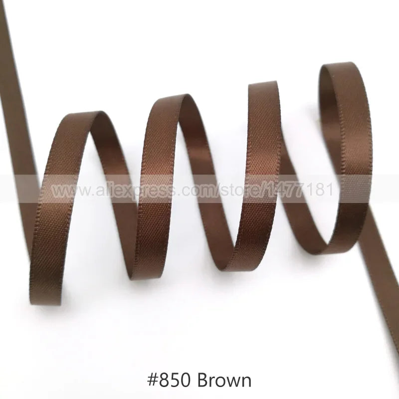 A brown satin ribbon is shown coiled and unwound, demonstrating its texture and drape.