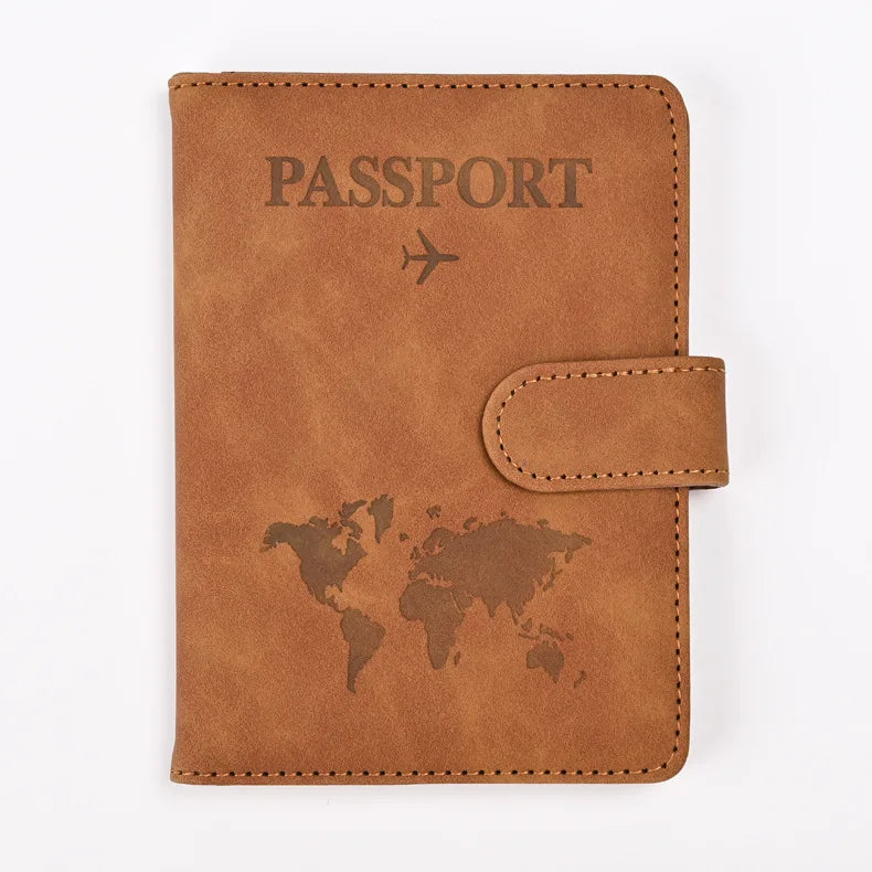 A brown leather passport holder with the word PASSPORT and a world map design on the cover.