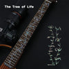 A close-up of a guitar fretboard featuring a Tree of Life inlay sticker decal.