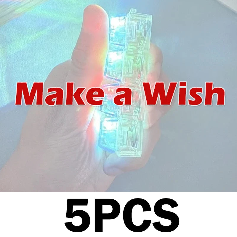 A hand holds a clear, light-up keyboard keychain fidget toy with five pieces.