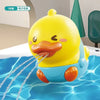 A yellow cartoon duck bath toy is shown with water flowing from its mouth in a blue bathtub.