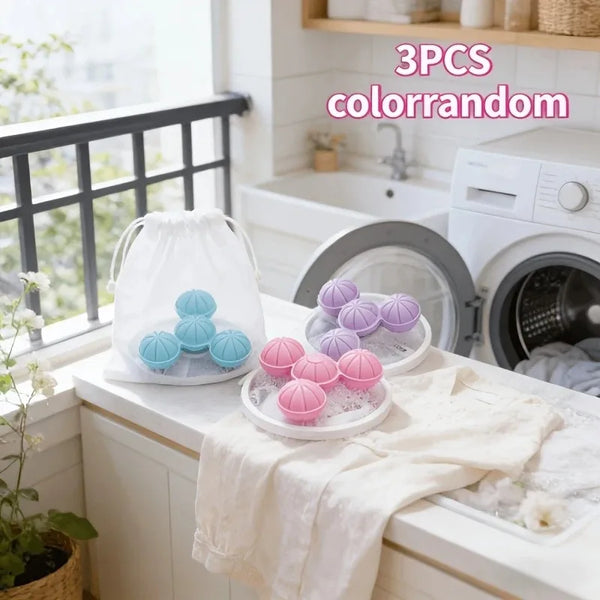 Three colorful silicone colrandom lint catchers displayed on a white countertop next to a washing machine.