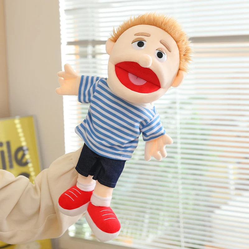 A hand puppet resembling a blonde character with red lips and blue striped shirt and dark shorts.