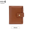 A brown leather bifold wallet with a stitched texture and a brass snap closure.
