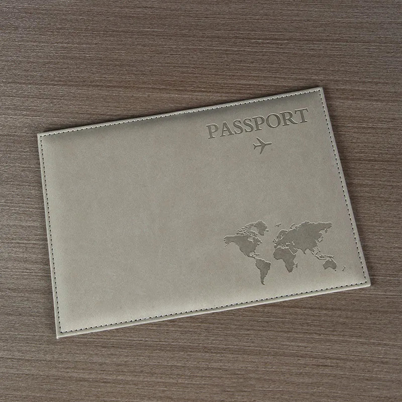 A light beige leather passport holder featuring a faint world map design and an airplane icon.