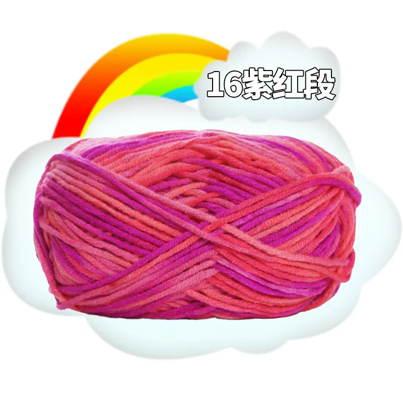 A ball of bright pink yarn with an orange rainbow background.