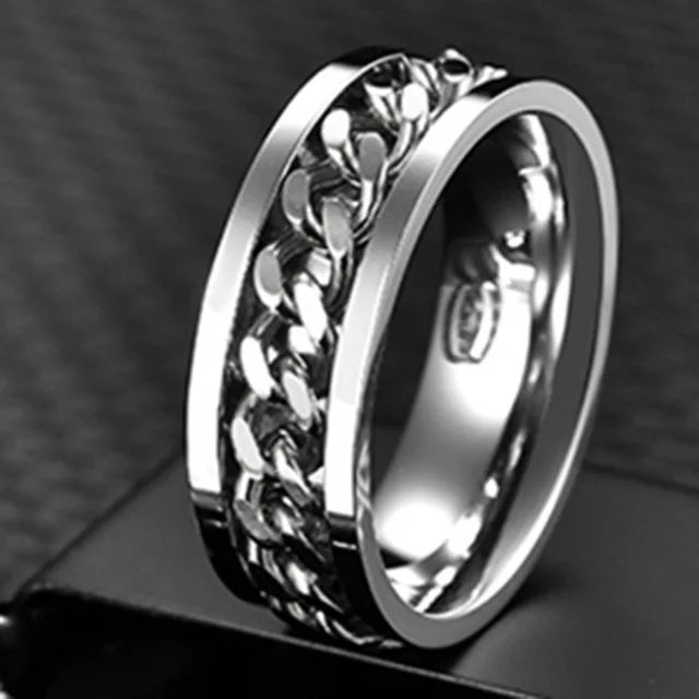 A close-up shot of a stainless steel spinner ring with a textured, link design.