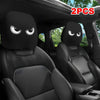 A pair of black car headrest covers with slanted eyes are shown inside a vehicle interior.