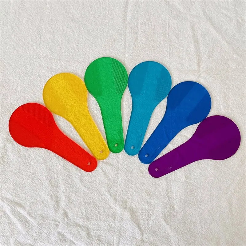 A set of nine colorful, translucent number counting tools for kids in various shades of green, yellow, blue, and purple.
