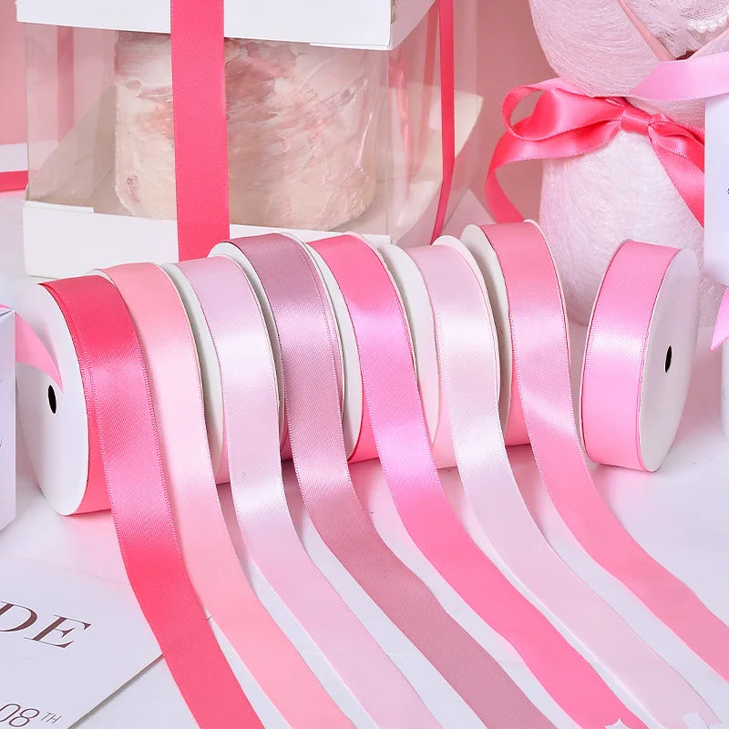 Rolls of pink and white satin ribbon for crafting or gift wrapping