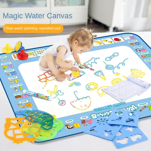 A toddler is drawing on a Magic Water Canvas mat with various colorful paint and tools.