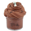 A jar of brown chocolate slime with a cork stopper and dark specks on top.