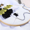 A set of 24 embroidery floss in white and black colors is displayed on a white surface.