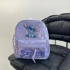 A lavender backpack featuring a Stitch design and iridescent glitter accents resting on a black leather chair.