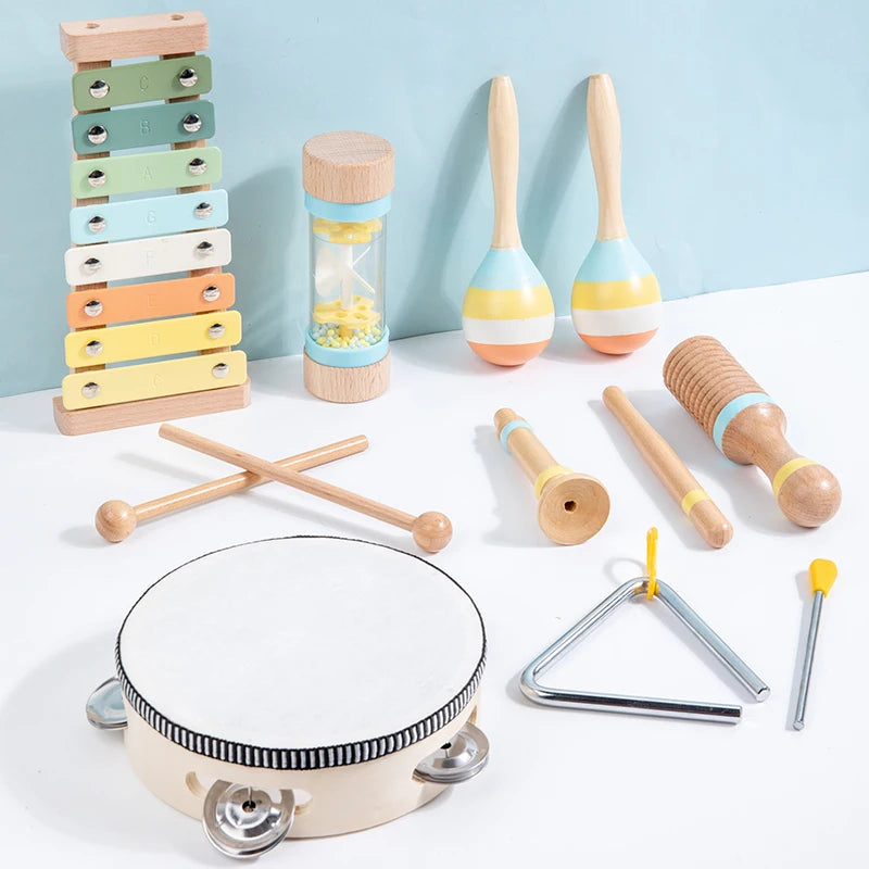 A set of wooden percussion instruments including maracas, mallets, and a large wooden cymbal/gong.