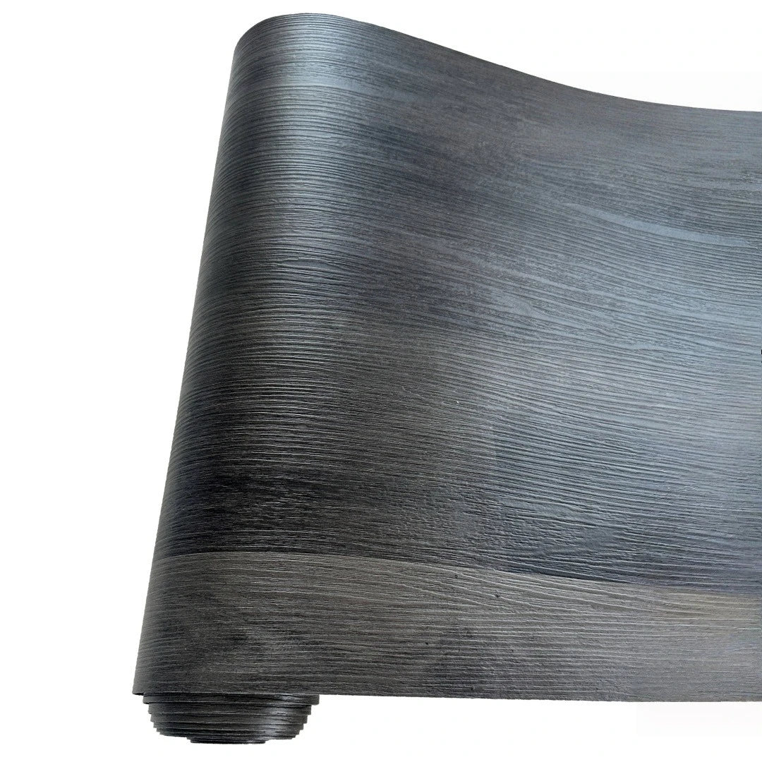 A roll of dark gray wood grain peel and stick wall decals made of waterproof PVC.