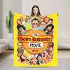 A yellow throw blanket featuring a cartoon illustration of characters from The Bob's Burgers movie poster.