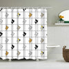 A white shower curtain featuring a repeating pattern of cute cartoon cats in yellow and black.