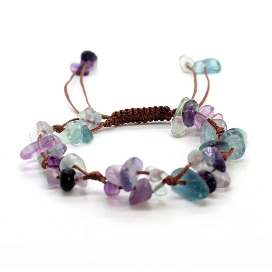 A bracelet made of braided natural crystal chips in shades of purple and blue quartz.