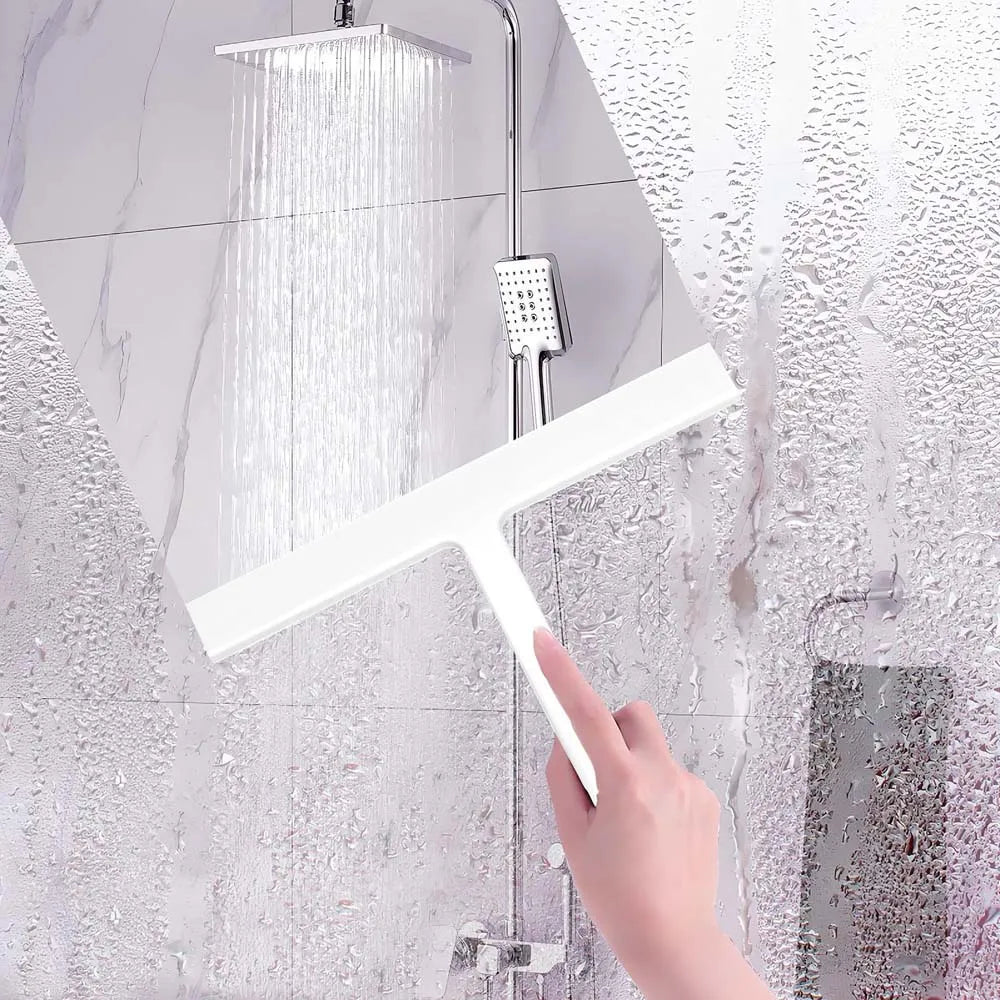 A hand is using a white soft silicone shower squeegee with a hanging hook to clean glass shower walls.
