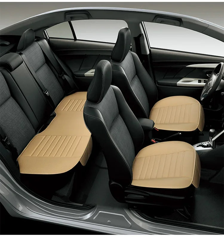 Interior view of a car with black seat covers featuring tan leather accents and breathable PU material.