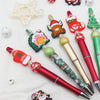 A collection of DIY beaded ballpoint pens featuring various Christmas-themed beads and designs.