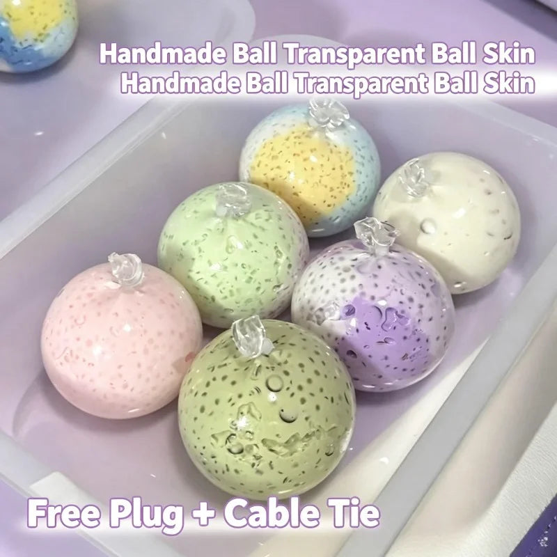 A collection of handmade transparent ball skin stress relief balls in various colors including yellow, green, pink, and purpl