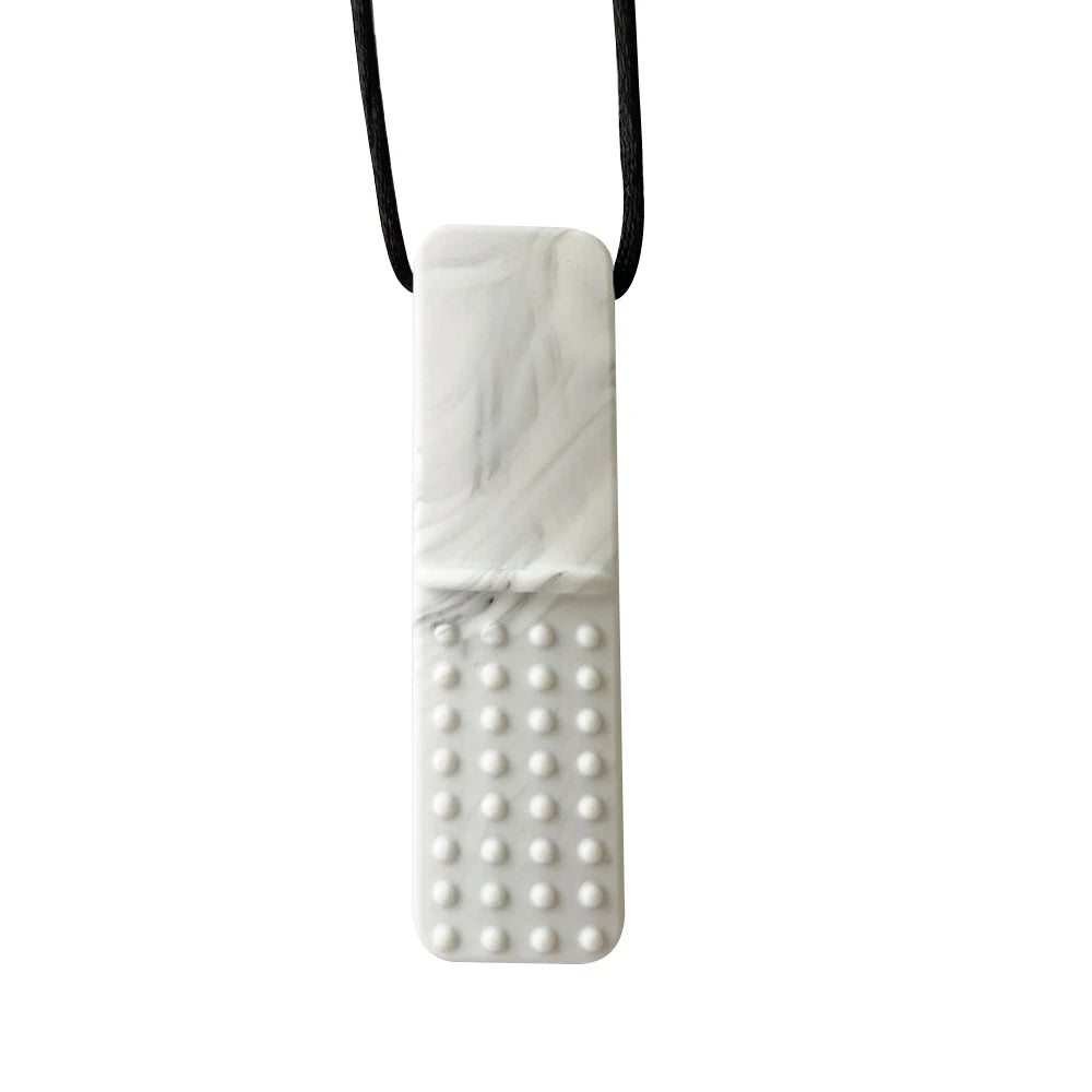 A white marbled silicone sensory chew necklace with a textured dome pendant on a black cord.