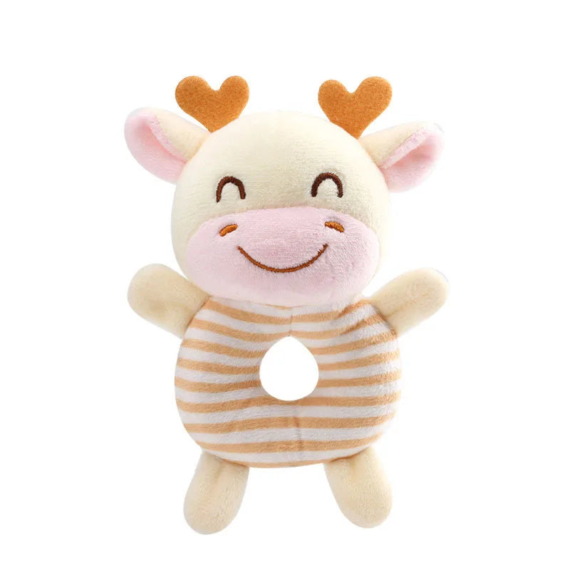 A soft plush baby rattle toy shaped like a cartoon animal with pink and beige fur and orange ears.