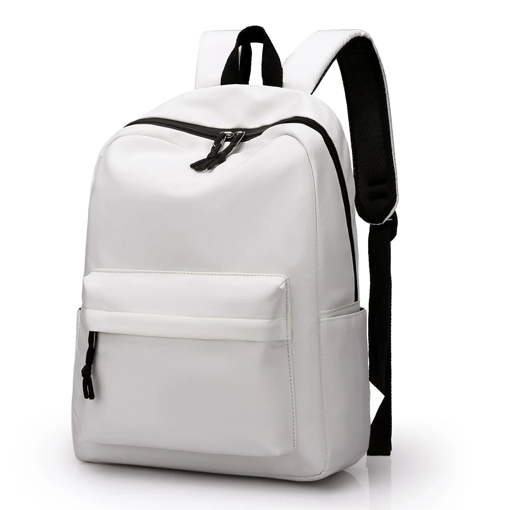 A white minimalist canvas backpack with black trim and straps shown from the front.