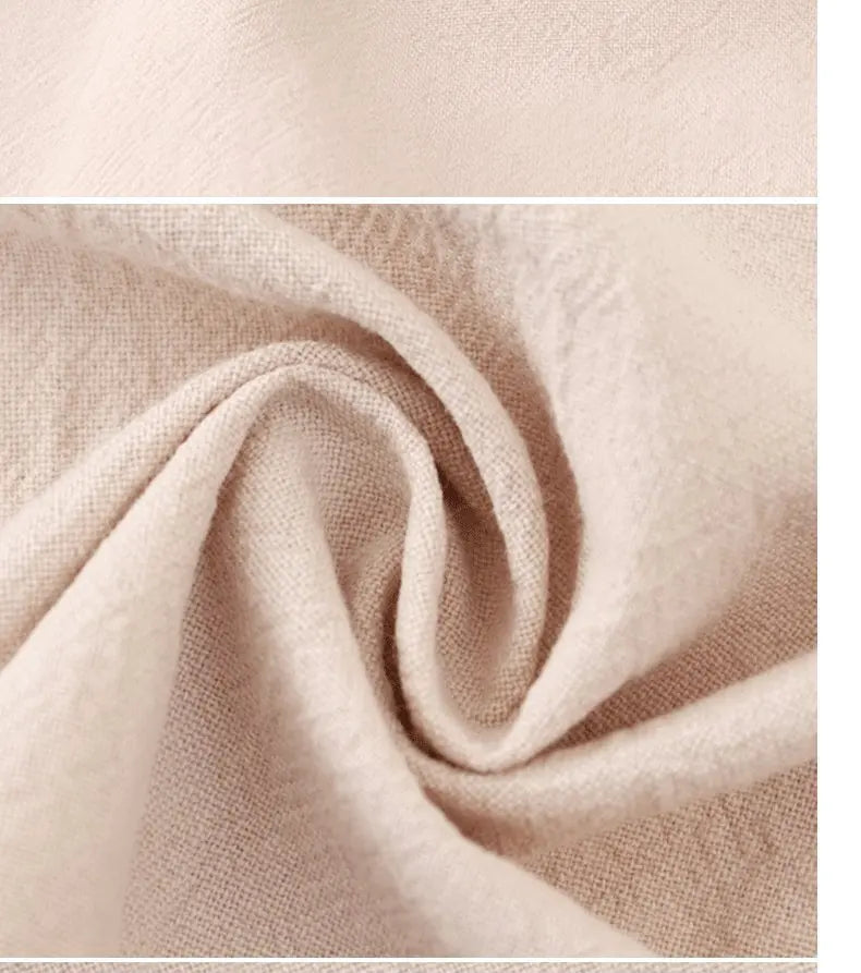 Close-up of a beige premium cotton kitchen apron fabric showing soft folds and texture.