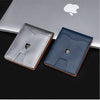 A silver and dark blue slim wallet with a carbon fiber texture is displayed on a black surface.