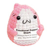 Pink shark plush ornament with black eyes and a smiling expression