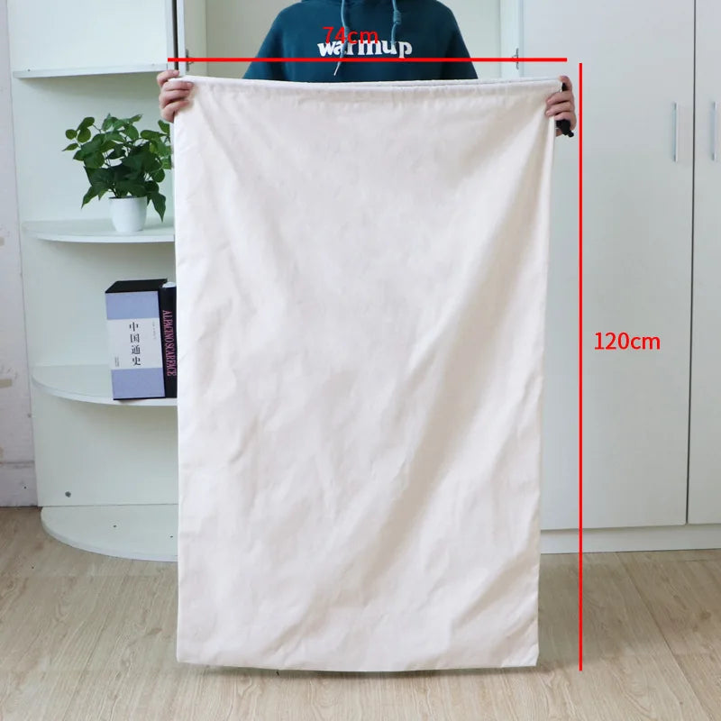 A large, light pink heavy-duty canvas laundry bag with a drawstring closure hanging vertically.