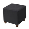 A dark gray stretch jacquard ottoman slipcover with an elastic edge shown from the side.