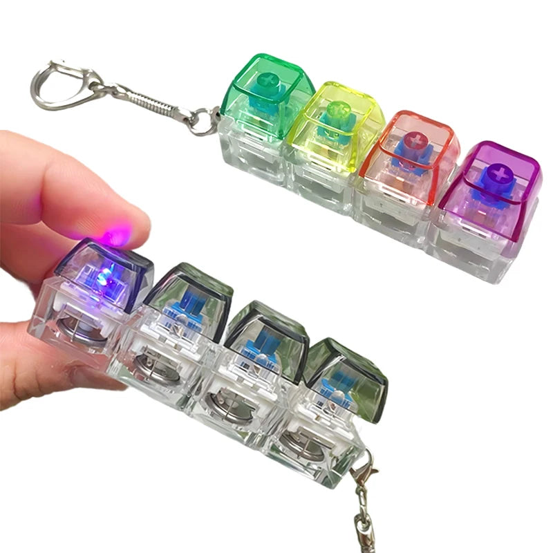 A set of colorful LED light-up keyboard fidget toys attached to a keychain.