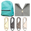 A collection of universal replacement zipper pulls in gold and silver finishes shown alongside a teal backpack.