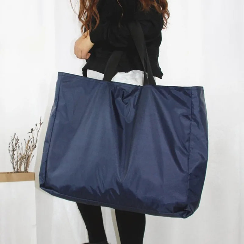 A navy blue reusable large-capacity grocery tote bag is shown hanging against a white background.