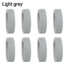 A set of light grey silicone luggage wheel protectors designed to prevent scratching and reduce noise during travel.
