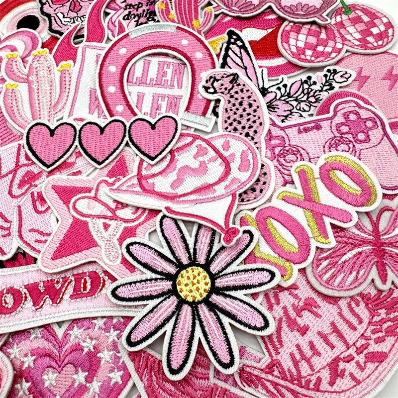 Assorted pink embroidered iron-on patches for DIY clothing and accessories featuring various shapes and designs